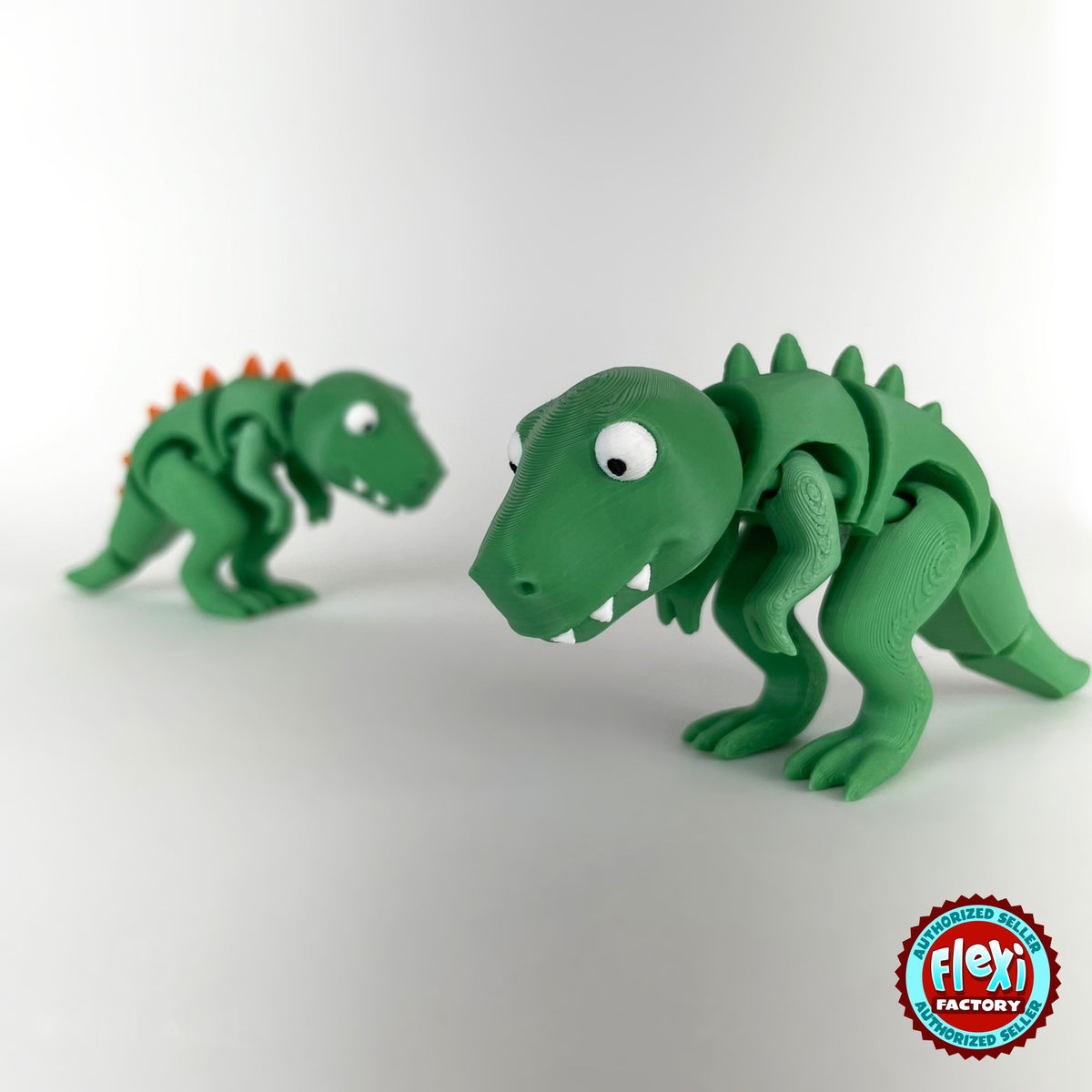 Cute T Rex dinosaur keychain, 3D printed by RU3D – pair of T Rex face to face. Green with orange spikes.