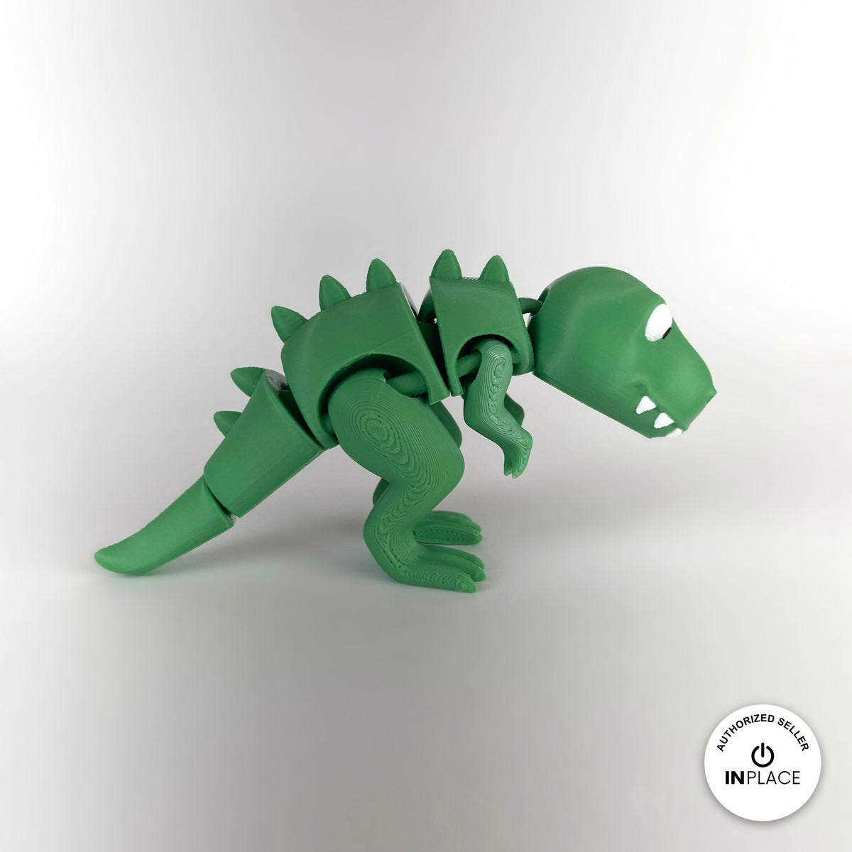 Cute T Rex dinosaur keychain, 3D printed by RU3D – side view facing right no spikes. Green with orange spikes.