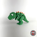Cute T Rex dinosaur keychain, 3D printed by RU3D – three quarter view facing left. Green with orange spikes.