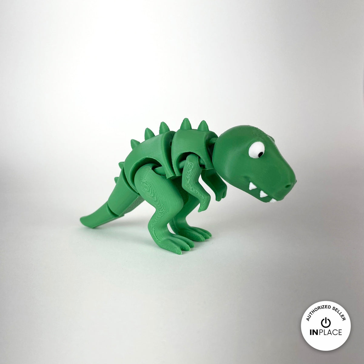Cute T Rex dinosaur keychain, 3D printed by RU3D – three quarter view facing right no spikes. Green with orange spikes.