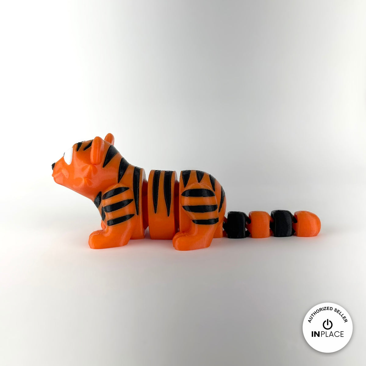 Cute tiger keychain, 3D printed by RU3D – side view facing left. Orange with black stripes.