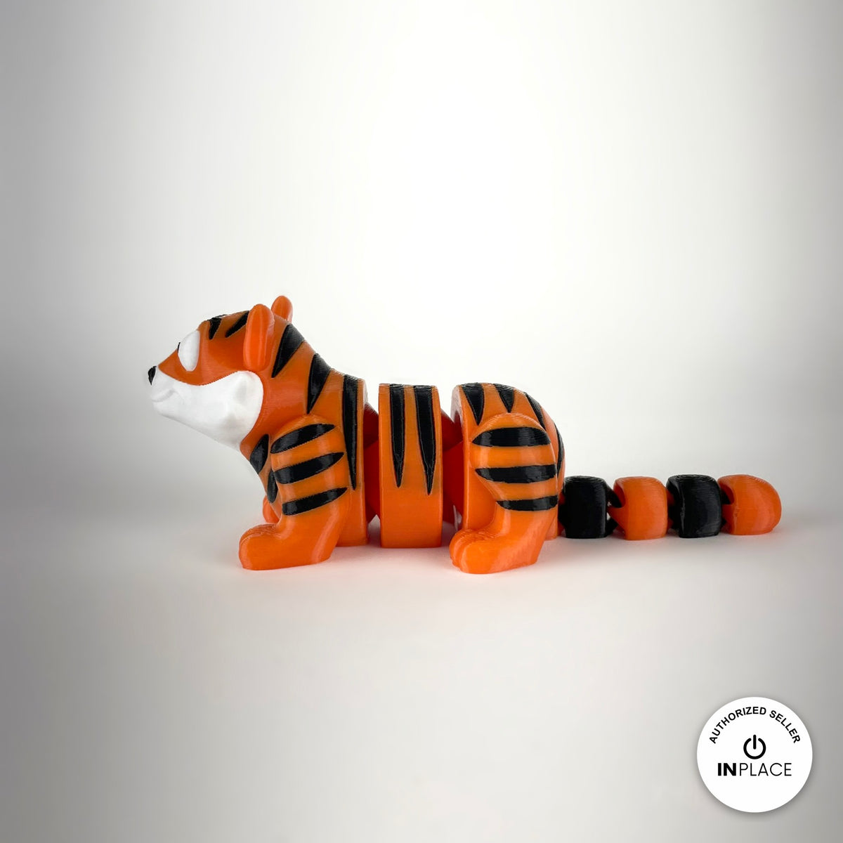 Cute tiger keychain, 3D printed by RU3D – white face side view facing left. Orange with black stripes.