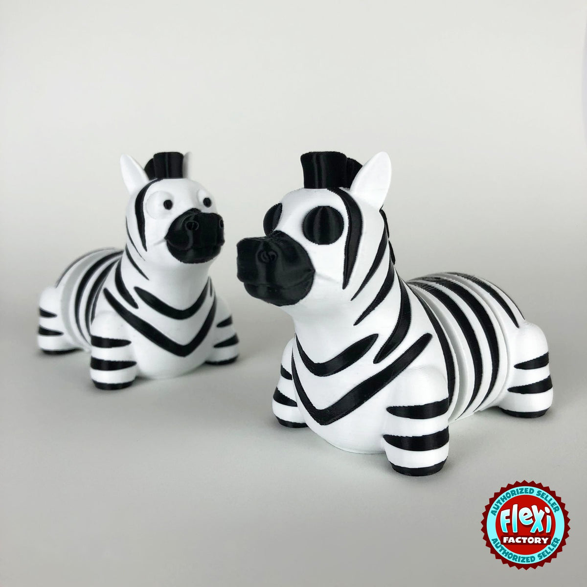 Cute zebra keychain, 3D printed by RU3D – pair of zebras face to face. Black and white stripes.