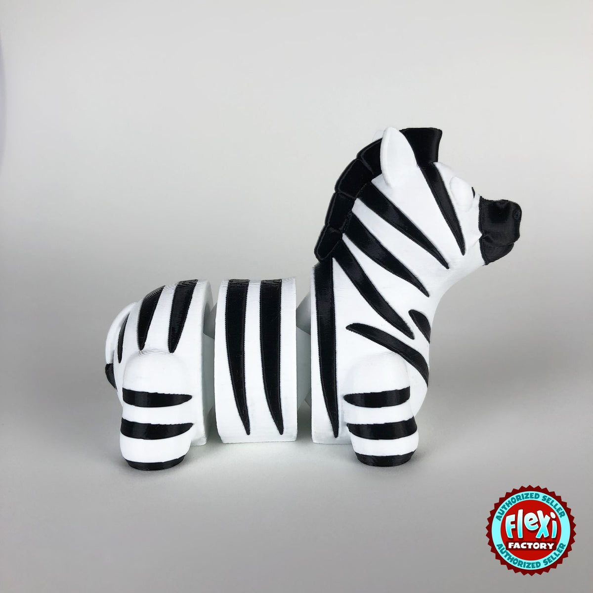 Cute zebra keychain, 3D printed by RU3D – side view facing right. Black and white stripes.