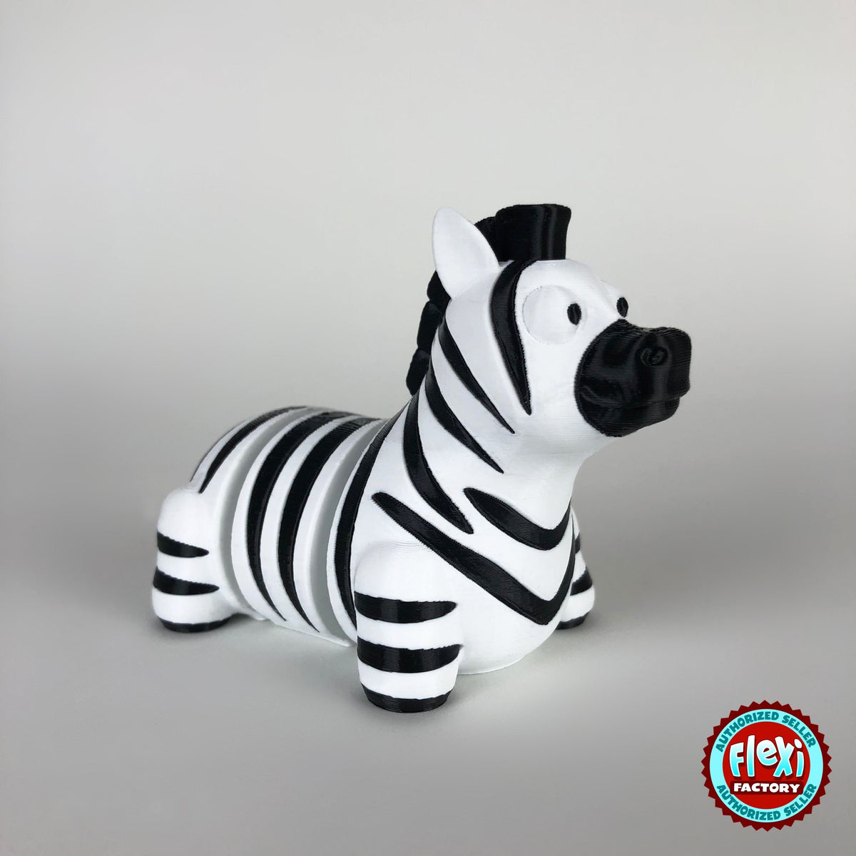 Cute zebra keychain, 3D printed by RU3D – three quarter view facing right. Black and white stripes.