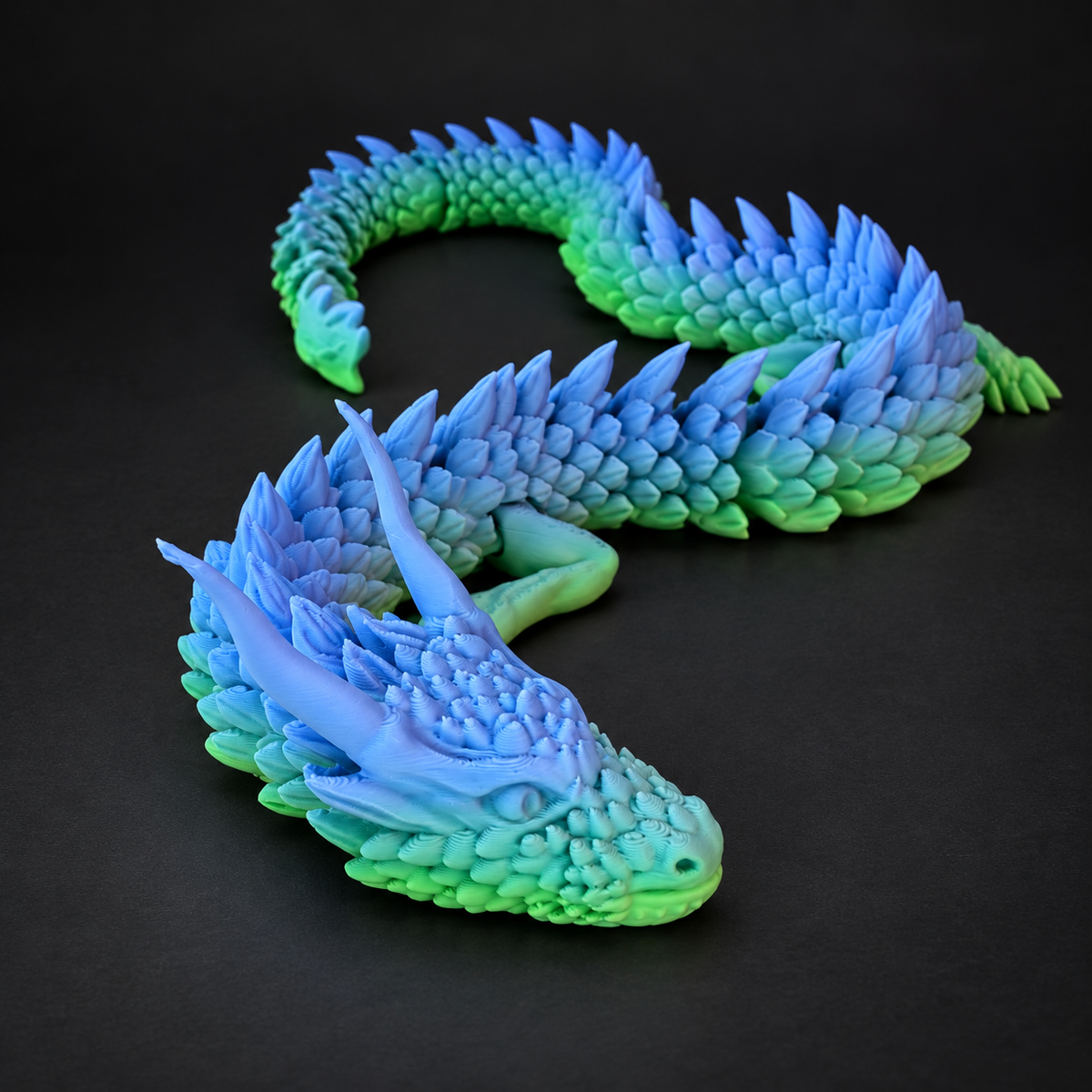 Articulated Flying Serpent with long flexible segmented body displayed on a dark charcoal studio background.