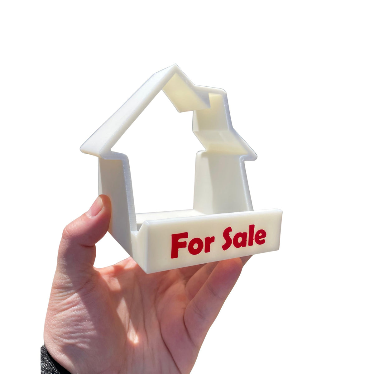 House-shaped For Sale phone and business card stand 3D printed by RU3D – held in hand