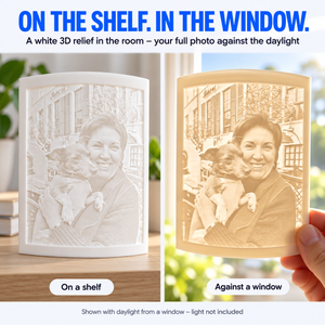 RU3D personalised 3D photo lithophane showing the same woman and dog portrait as a white textured print on a shelf and illuminated by daylight against a window.