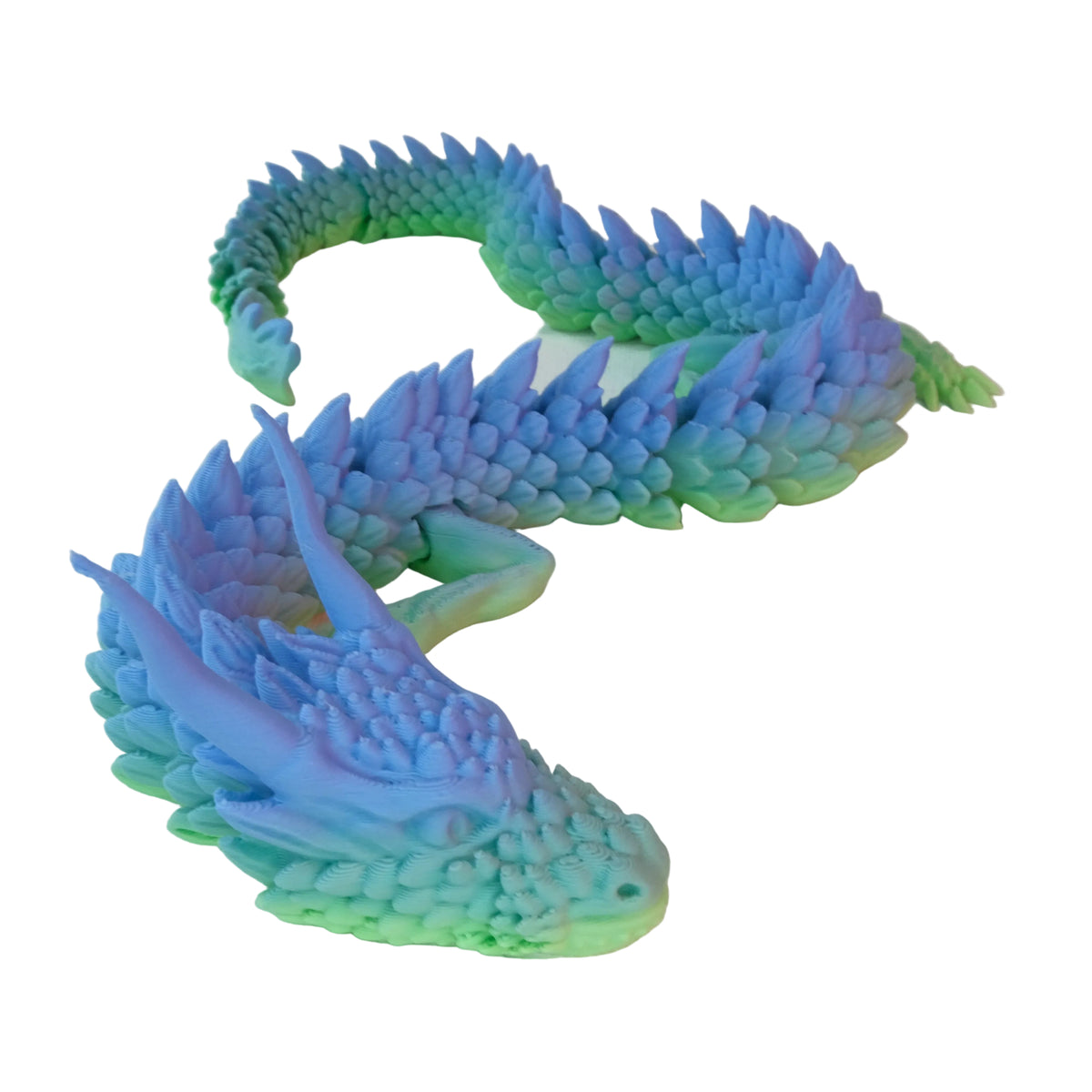 A multicoloured dragon figurine with an organic shape, featuring articulated segments and a glossy finish. It has blue and green scales and a sinuous body.