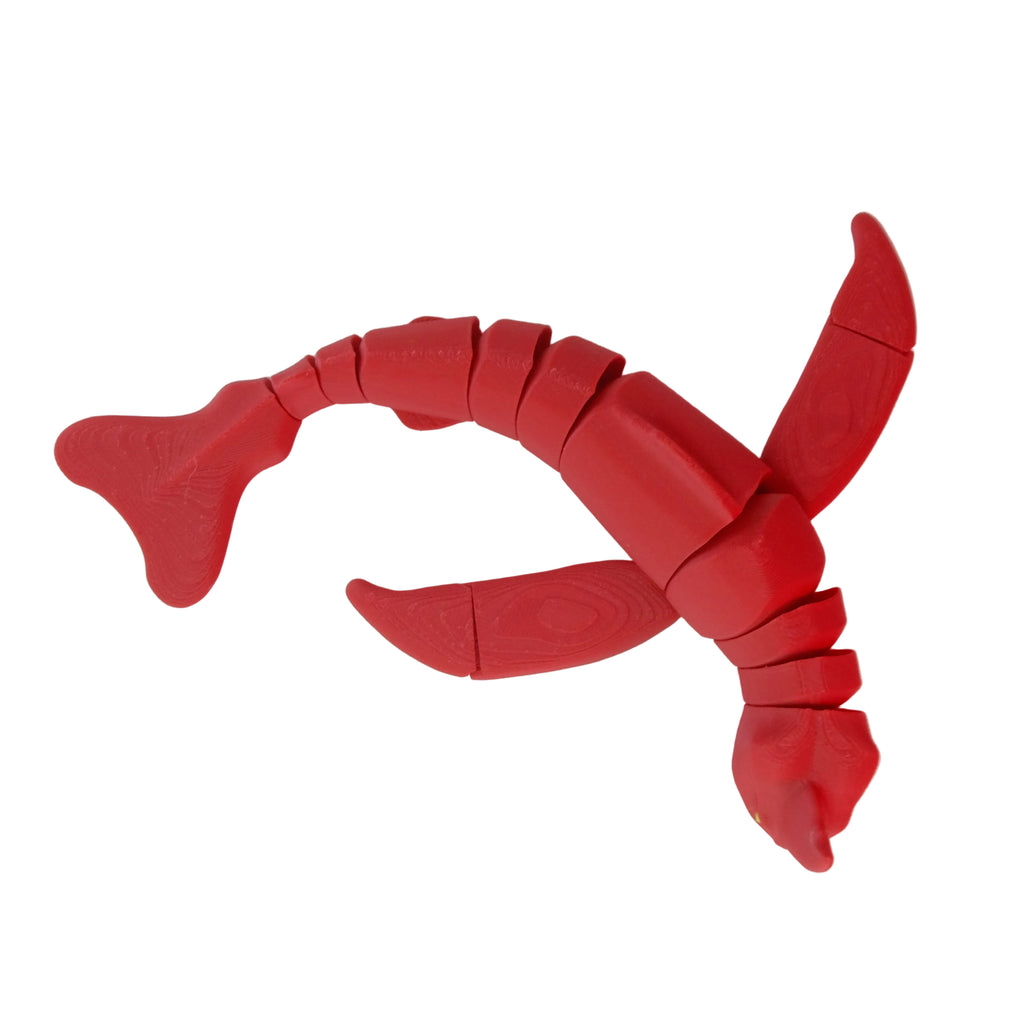 A red articulated crab-shaped figure with movable limbs, posed on a white surface.