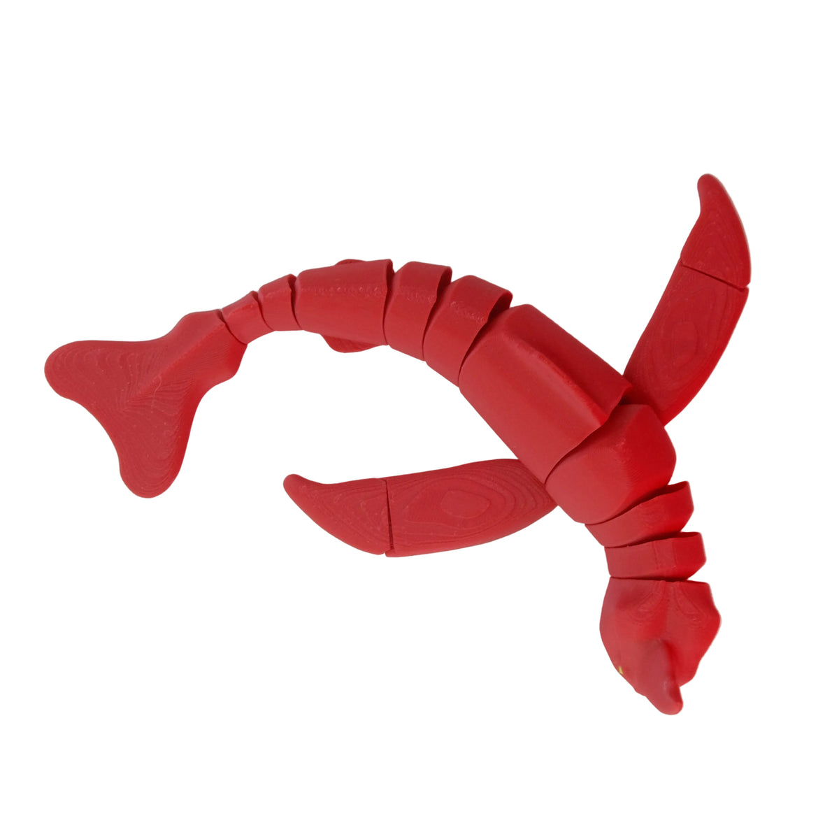 A red articulated crab-shaped figure with movable limbs, posed on a white surface.