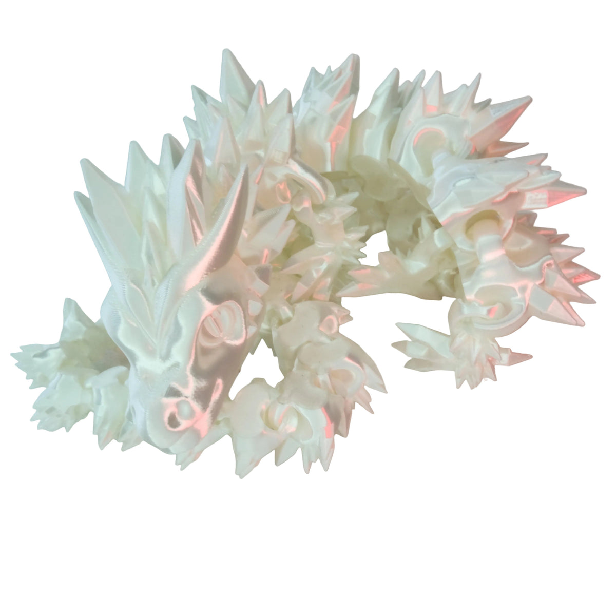 A detailed white dragon figurine with spiky features and a glossy finish, resting on a white surface.