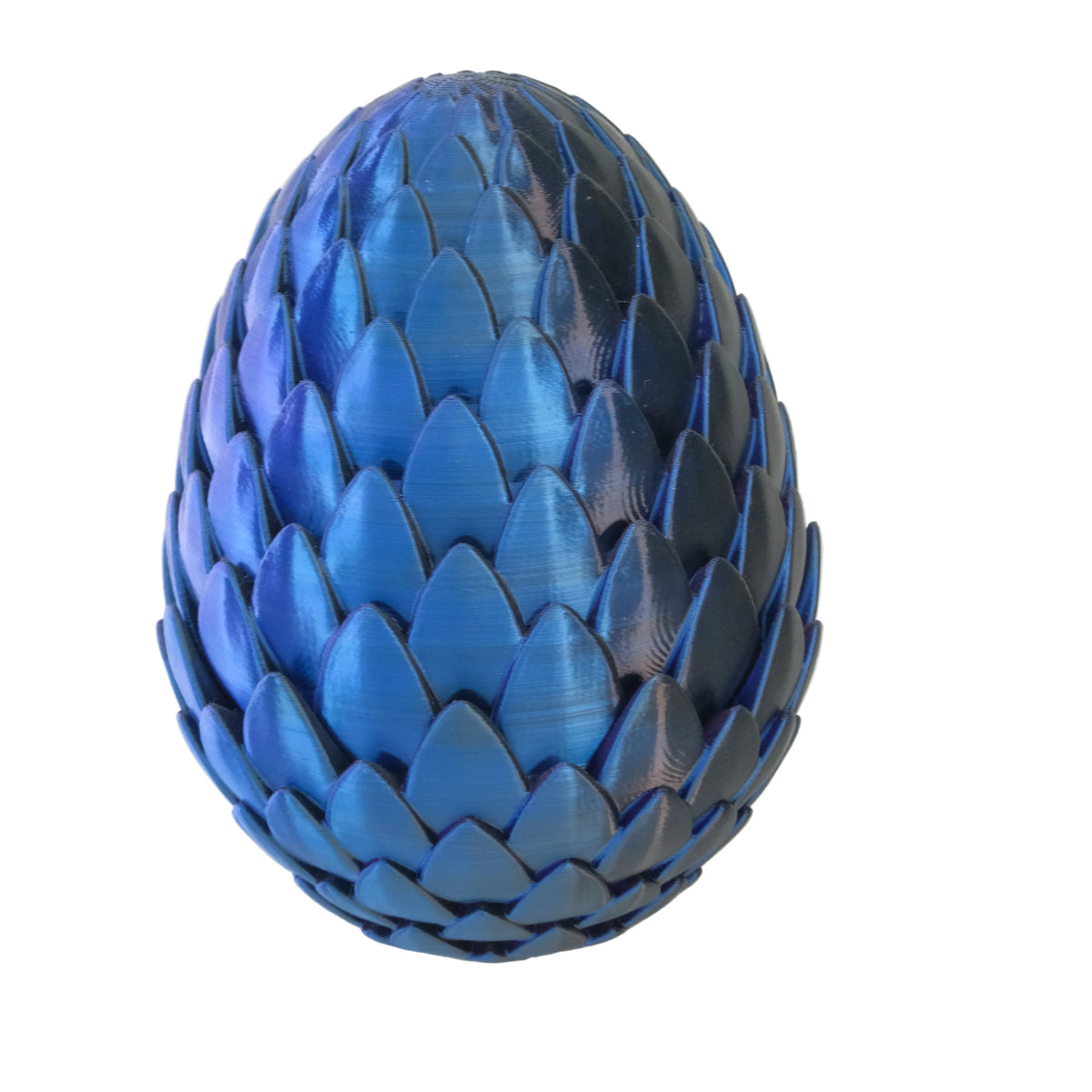 A shiny blue ornamental egg with geometric scale-like patterns, resembling a pine cone in shape.