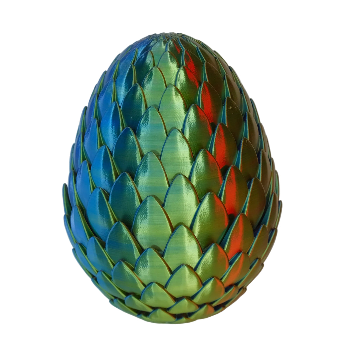 A decorative egg shape with a colorful, iridescent finish, resembling scales, sitting on a white surface.