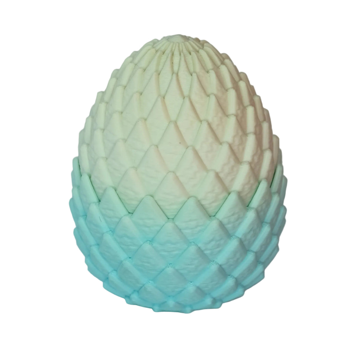 An ornate ornament in the shape of an egg, featuring a gradient from white to light blue with a textured surface resembling scales.