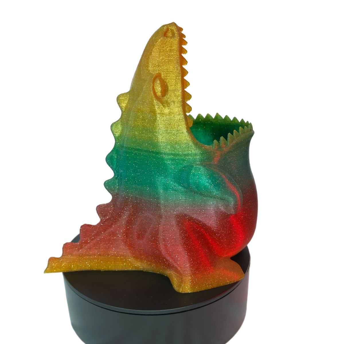 A multi-coloured shark figurine with a glossy finish, featuring articulated teeth and a distinctive design.