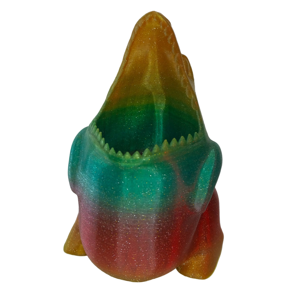 A multicoloured shark figurine featuring a glossy finish and an open mouth with sharp teeth.