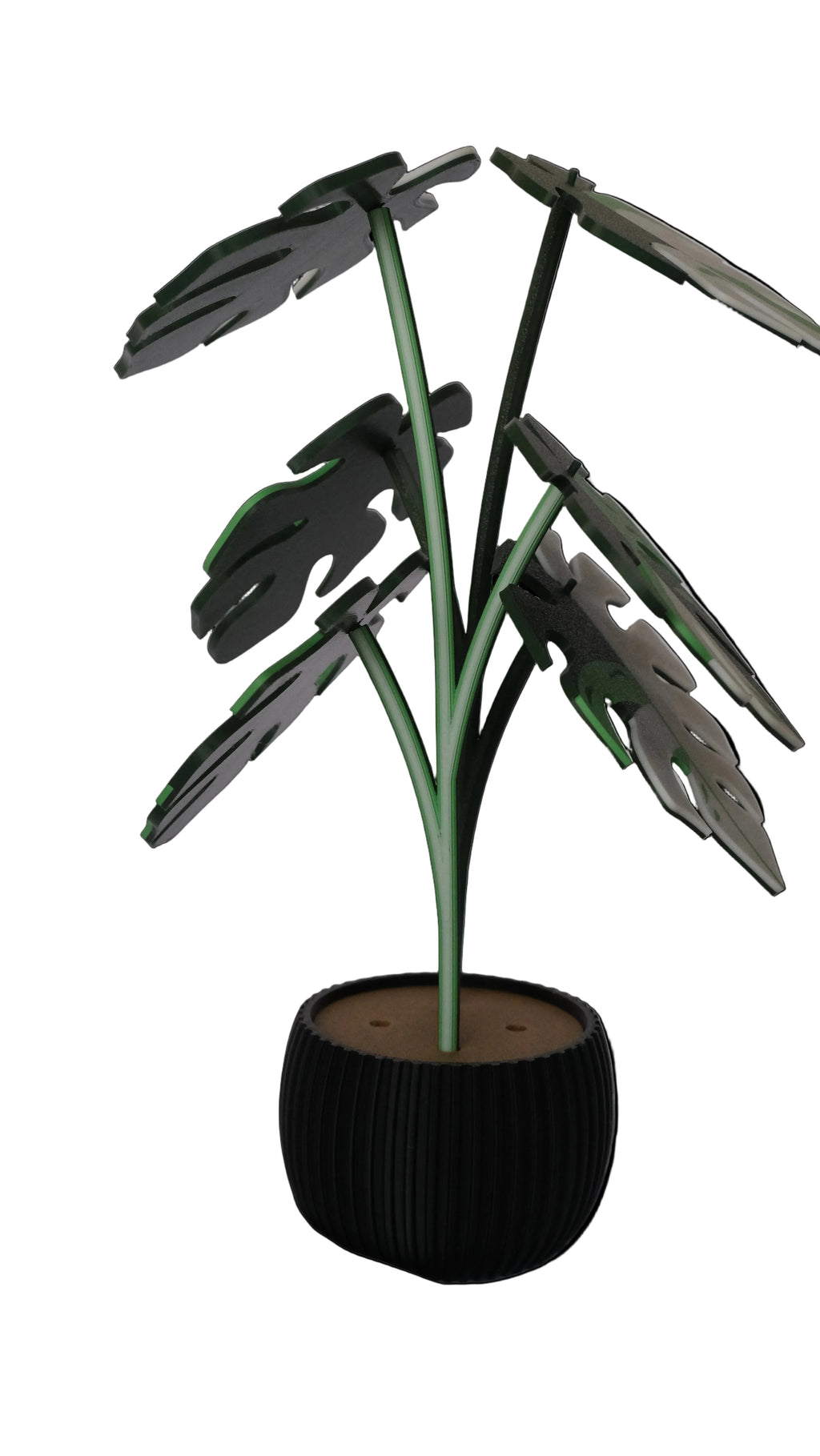 A decorative potted plant with green leaves shaped like a monstera, resting in a black ribbed planter.