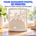3D photo lithophane by RU3D featuring a couple's portrait, displayed on a wooden windowsill with natural daylight revealing the personalised 3D printed photo.