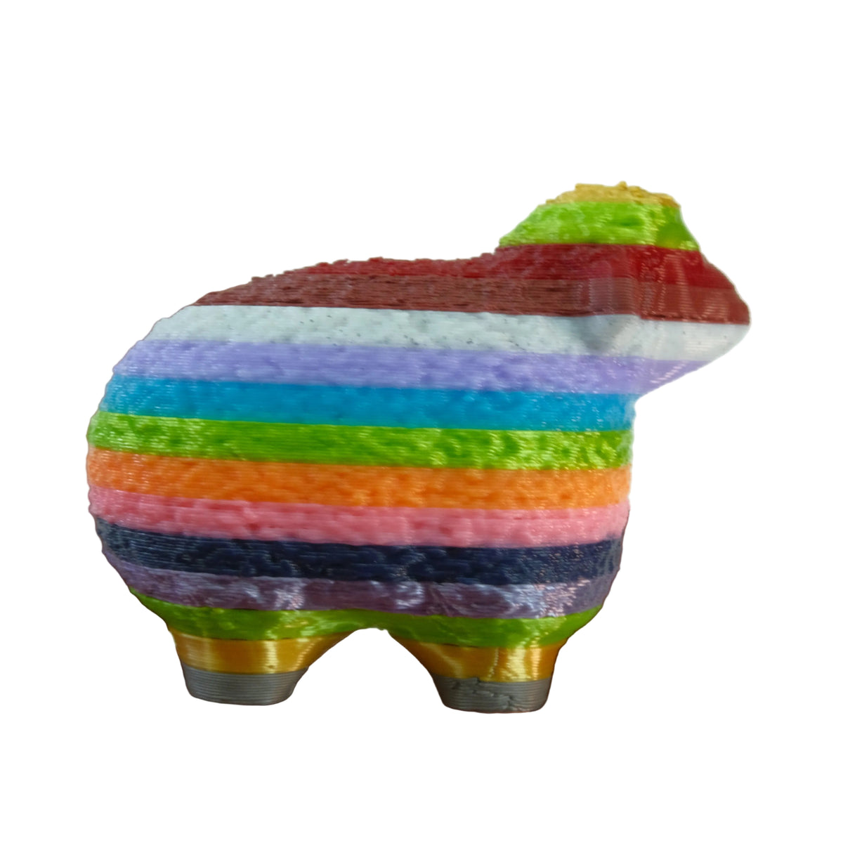 A small, multicoloured figurine shaped like a dog, featuring wide horizontal stripes in various bright colors.