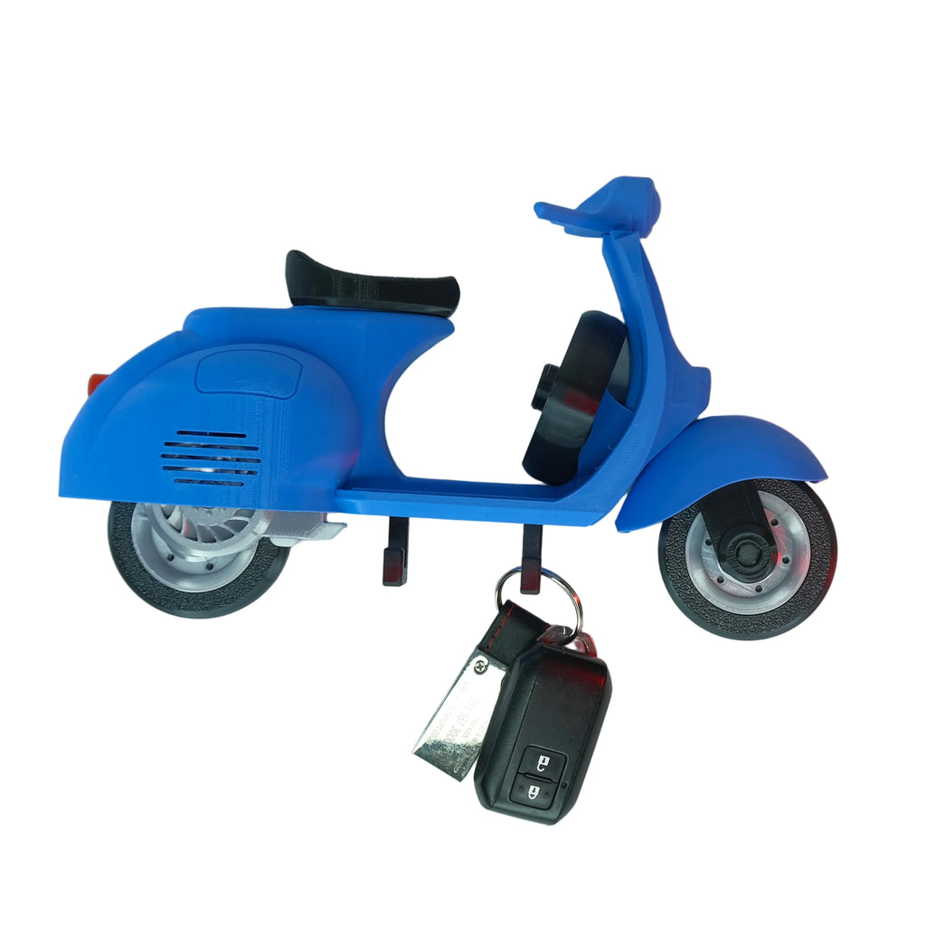 A blue scooter-shaped keychain with smooth surfaces and a realistic design.