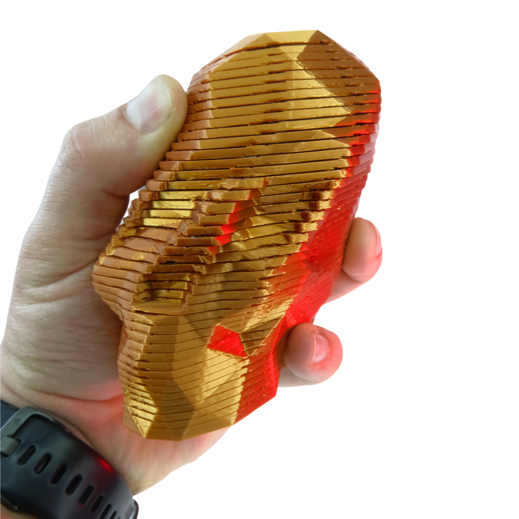 A geometric, multicolour toy held in a hand, showcasing glossy surfaces and layered design elements.