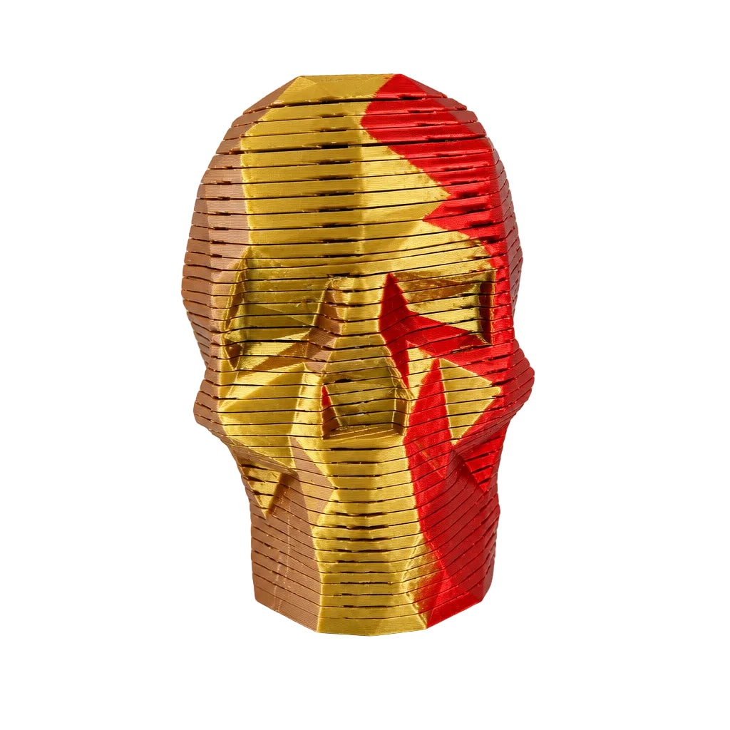 A hand holding a geometric object with gold and red colors, featuring sharp edges and distinct folds.