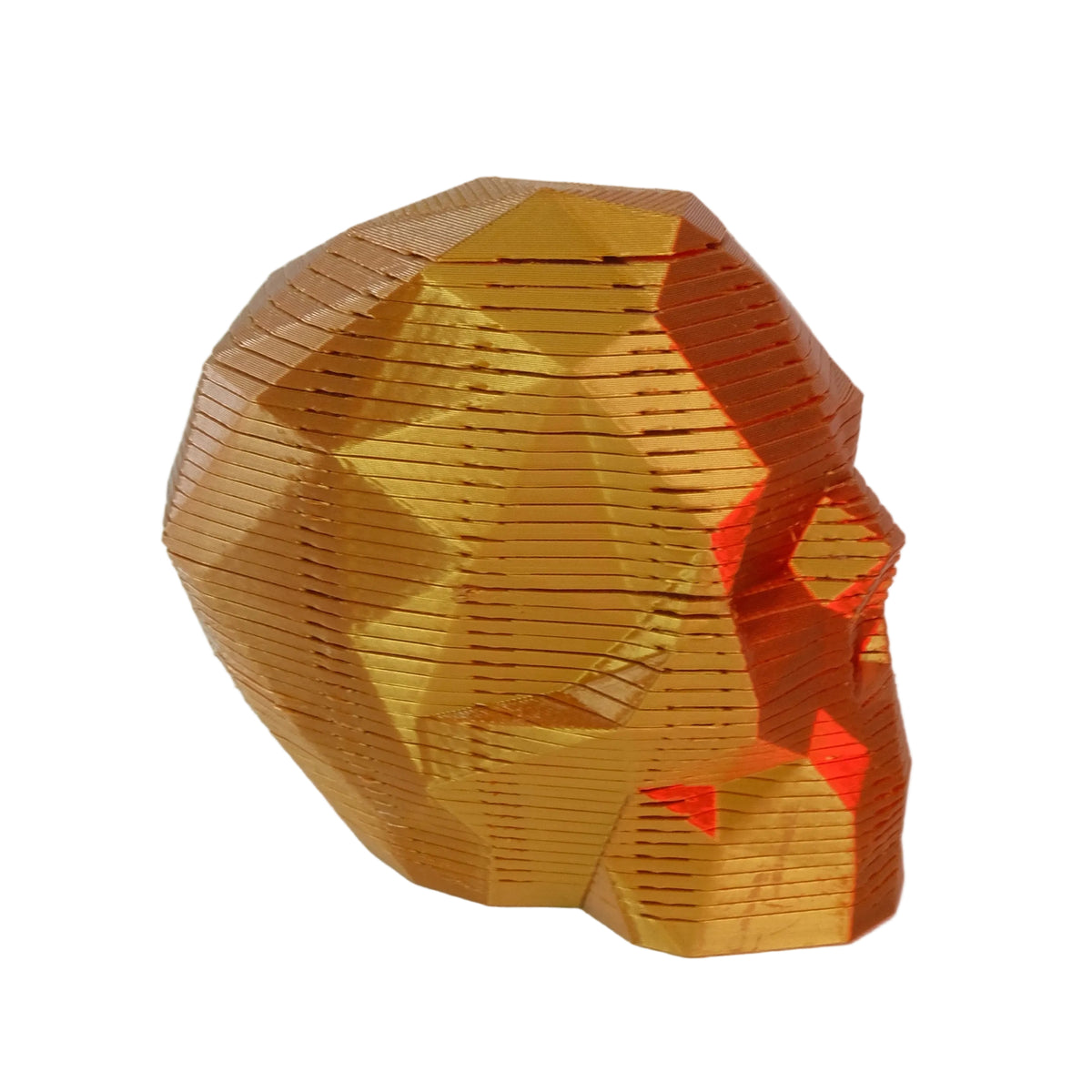 A geometric skull-shaped figurine in a metallic orange finish with a textured surface.